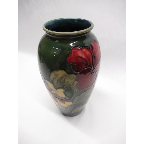 286 - Moorcroft ovoid vase decorated in Hibiscus pattern on a green ground, impressed marks, green signatu... 