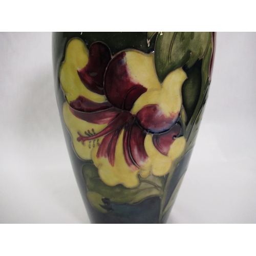 286 - Moorcroft ovoid vase decorated in Hibiscus pattern on a green ground, impressed marks, green signatu... 