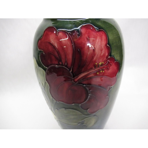 286 - Moorcroft ovoid vase decorated in Hibiscus pattern on a green ground, impressed marks, green signatu... 