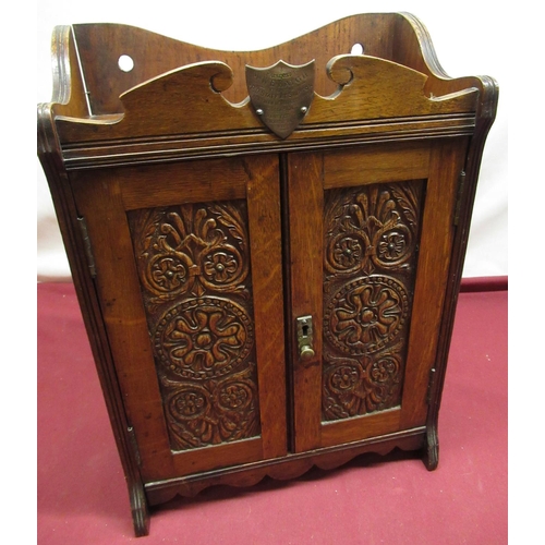55 - Edwardian oak smokers cabinet, carved rosette twin doors with two drawer fitted interior, with prese... 