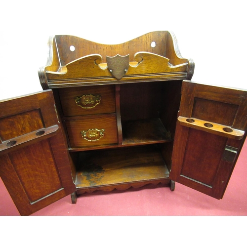55 - Edwardian oak smokers cabinet, carved rosette twin doors with two drawer fitted interior, with prese... 