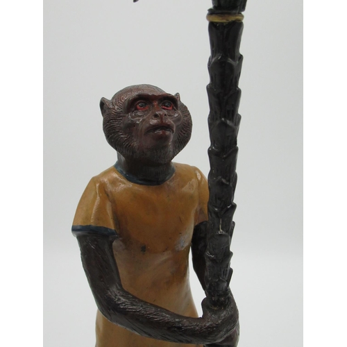 124 - Painted bronze candlestick in the form of monkey supporting branch, with urn sconce, H37cm