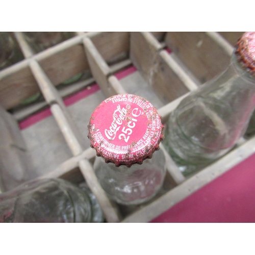 242 - Vintage Coca Cola wooden crate with eight original glass Coca Cola bottles (stamped for delivery to ... 