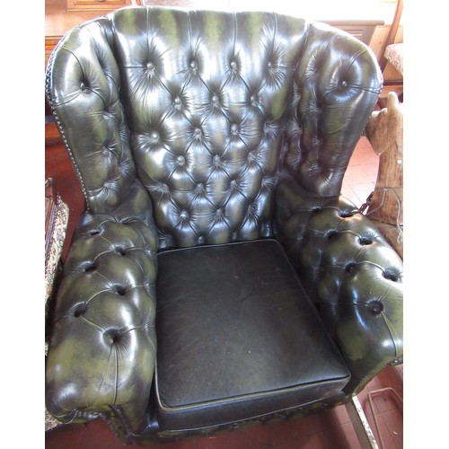 562 - Green leather upholstered arm chair with deep buttoned back and arms and loose seat cushion, W80cm D... 