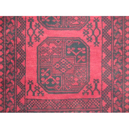 1460 - C20th traditional pattern wool runner, red ground with six central geometric pattern medallions, sur... 