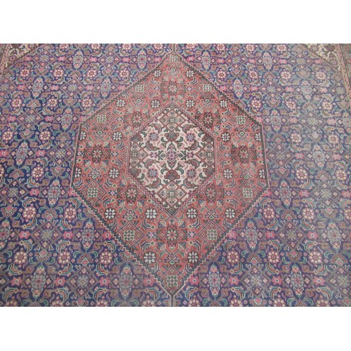 1462 - C20th Iranian Tabriz wool rug, salmon pink ground with central hexagonal medallion with stylized flo... 