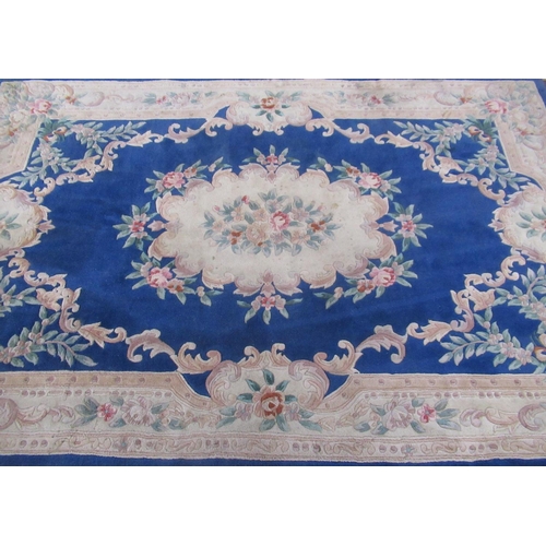 360 - Chinese embossed washed woolen rug, blue ground with central medallion and floral patterned border, ... 