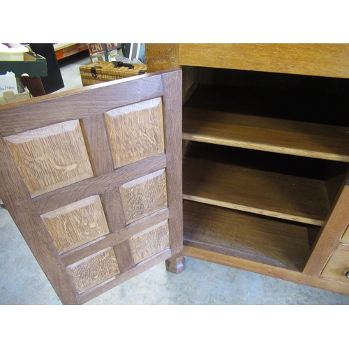 1475 - Sid Pollard of Thirsk - Oak sideboard with raised back and four drawers enclosed by two six panelled... 