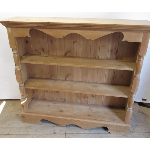 1538 - Waxed pine bookcase, moulded top with shaped frieze above two shelves enclosed by baluster columns o... 