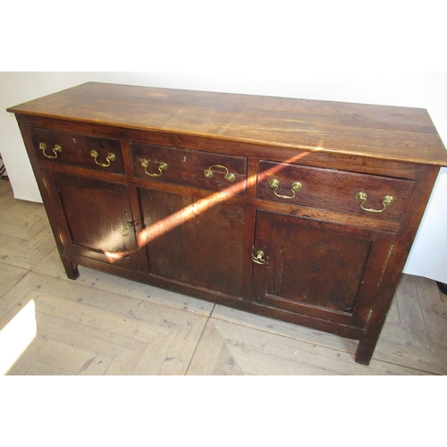 1540 - Late C18th oak dresser, with three frieze drawers with brass swan necked handles above two panelled ... 