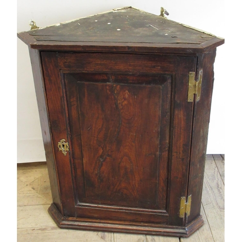 1541 - Small Geo. III oak corner cupboard, fielded panel door with brass H hinges enclosing two shelves, wi... 