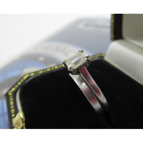 1124 - Hallmarked platinum solitaire ring with emerald cut diamond in four claw setting, 0.70ct, colour H, ... 