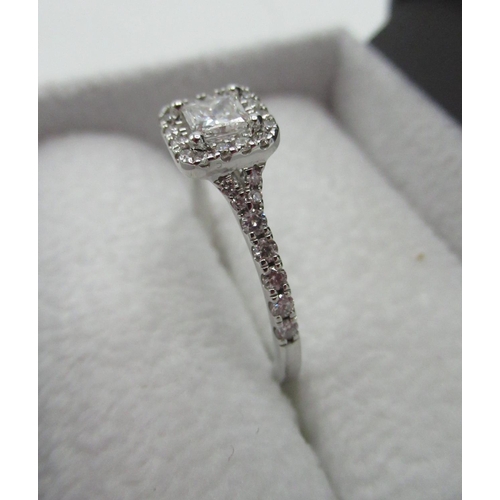 1127 - Hallmarked 18ct white gold and diamond ring with central princess cut diamond, a halo of sixteen rou... 