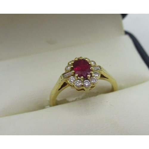 1130 - Hallmarked 18ct yellow gold diamond and ruby cluster ring with central oval cut ruby, ten round cut ... 