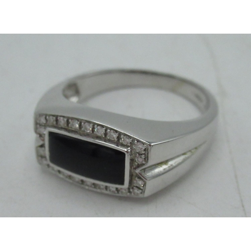 1123 - 18ct white gold and diamond ring with a rectangular cabochon onyx and a halo of twenty-two round cut... 