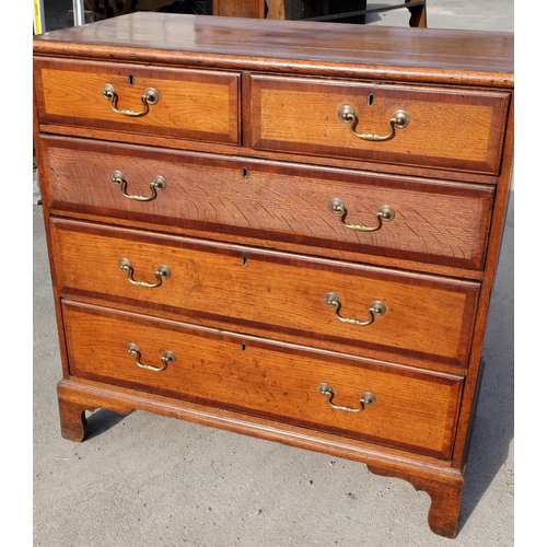 1557 - Geo. III mahogany cross banded oak chest of two short above three long moulded drawers, with brass s... 