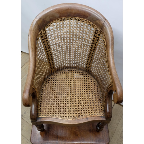 1560 - Early C19th child's correction chair, canework curved back with scrolled arms and serpentine seat, o... 