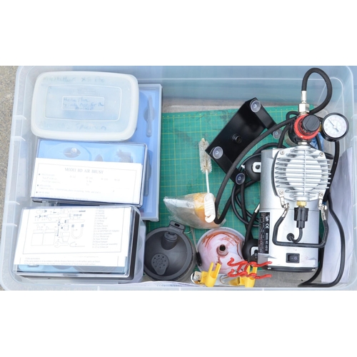 114 - Plastic storage box containing air brush equipment including small table top compressor, boxed air b... 