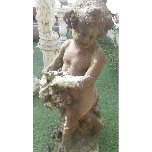 52 - Composite figure of a cherub holding fruit on plinth