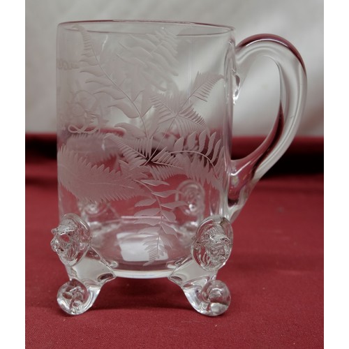 1360 - C19th glass tankard with loop handle on scrolled lion prunt feet, engraved with ferns and monogramme... 