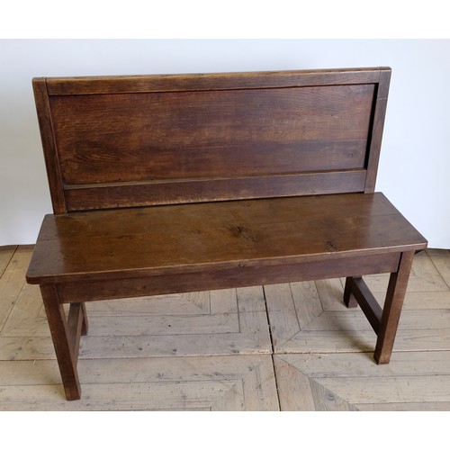 1555 - Early C20th oak bench seat, with panelled back and open arms on square supports joined by stretchers... 