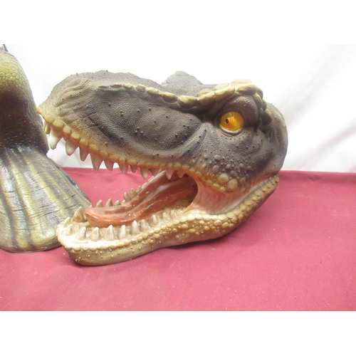 85 - Two resin Tyrannosaurus Rex wall mounting heads, four plastic Velociraptor heads and hands (6)