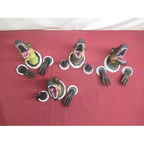 85 - Two resin Tyrannosaurus Rex wall mounting heads, four plastic Velociraptor heads and hands (6)