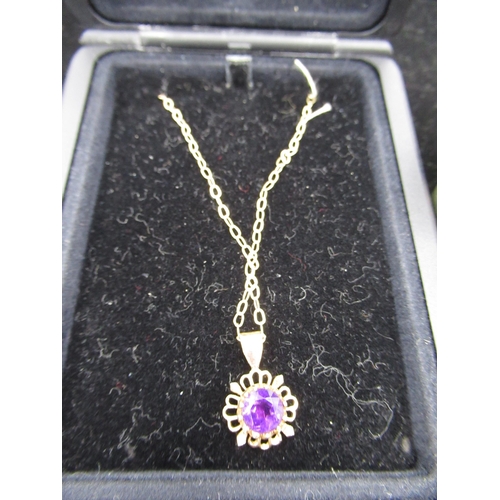 27 - 9ct yellow gold necklace with round cut purple stone in a pierced mount, a yellow metal ring with ba... 