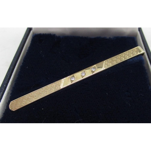 35 - Hallmarked 9ct yellow gold engine turned tie slide inset with three brilliant cut diamonds and safet... 