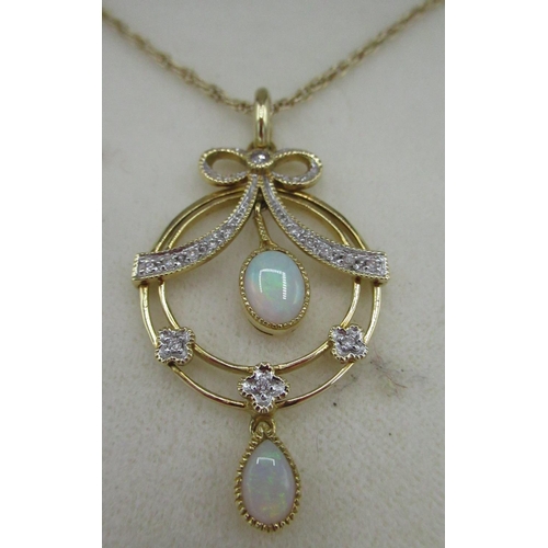 40 - Hallmarked 9ct yellow gold opal and diamond circular pendant, round cut diamonds inset in ribbon eff... 