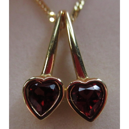47 - 18ct yellow gold pendant with two garnets inset in cherry shaped mount, L2cm, 750, London, 2000 on a... 