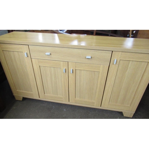 518 - Modern beech laminate sideboard with central drawer above two cupboard doors flanked by two other cu... 