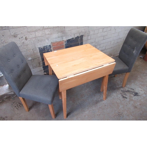 519 - Small kitchen lightwood drop leaf table and a pair of grey upholstered dining chairs (3)