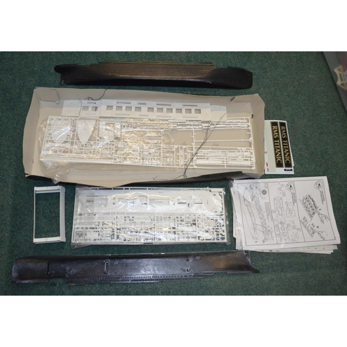 49 - Opened plastic ship model kits including Queen Mary, Titanic etc, number of started built and damage... 