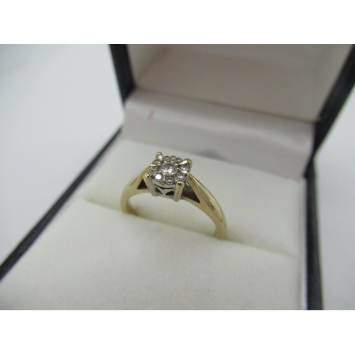 10 - Hallmarked 9ct yellow gold diamond ring with a central round cut diamond and a halo of eight smaller... 