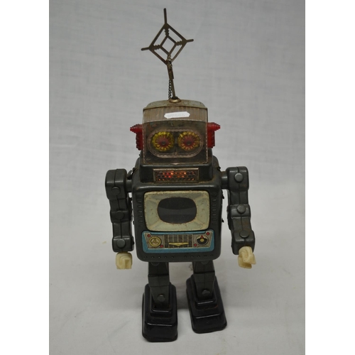 61 - Vintage tin plate walking battery operated robot, works intermittently.