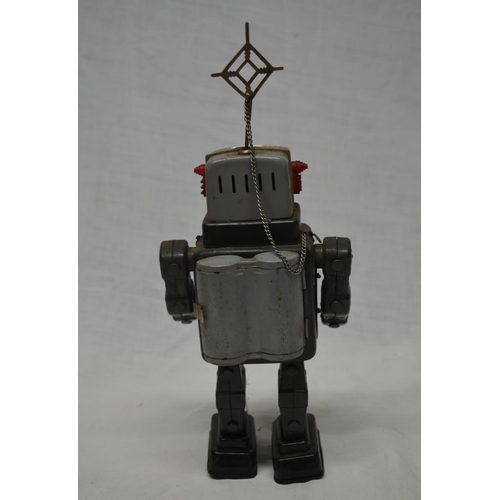 61 - Vintage tin plate walking battery operated robot, works intermittently.