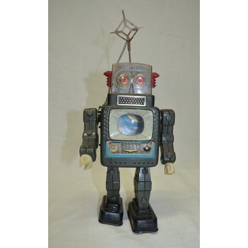 61 - Vintage tin plate walking battery operated robot, works intermittently.