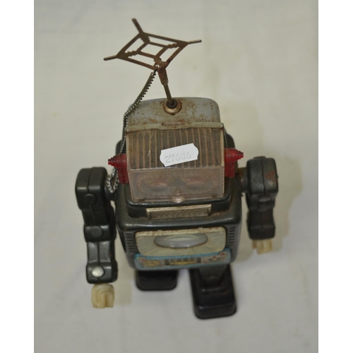 61 - Vintage tin plate walking battery operated robot, works intermittently.