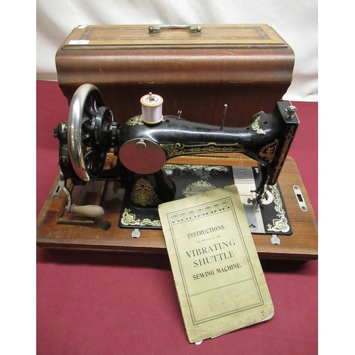 107 - Cased vintage vibrating shuttle sewing machine, hand operated, instruction book and trade label for ... 