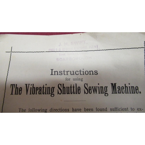 107 - Cased vintage vibrating shuttle sewing machine, hand operated, instruction book and trade label for ... 