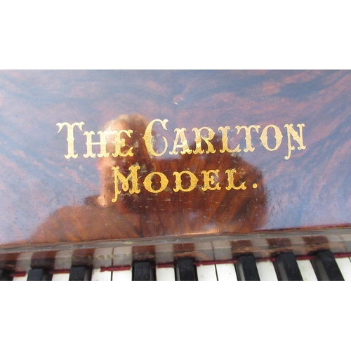 781 - Walnut cased upright piano marked the Carlton model