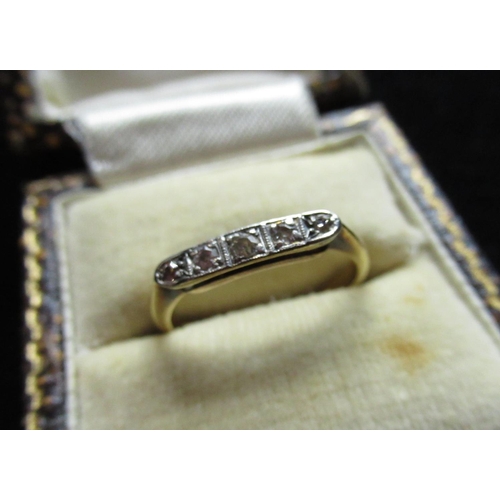 5 - Yellow metal diamond five stone ring, graduated round cut diamonds inset in a platinum mount, marks ... 