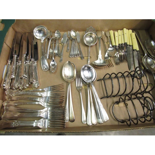 253 - Collection of silver plate-ware including cutlery, toast racks, serving utensils, etc