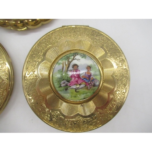 239 - KIGU gilt circular engine turned compacts, one with cameo cover, one with hinged portrait cover and ... 