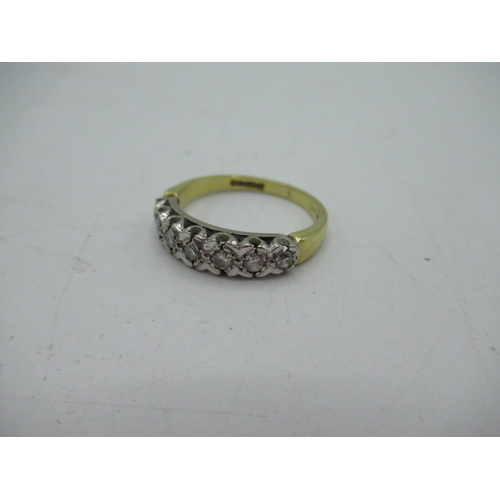7 - Hallmarked 18ct yellow gold diamond ring, seven round cut diamonds inset in a white metal illusion m... 
