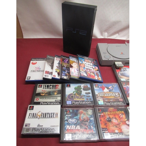799 - Playstation and PS2 consoles with games and controllers
