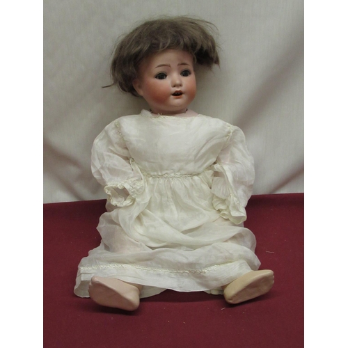 886 - Heubach Koppelsdorf bisque headed doll model 321.0 wearing brown wig and silk dress, H43cm