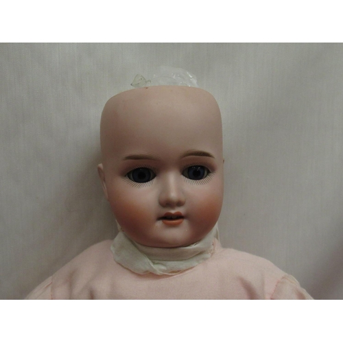 889 - Schoenau & Hoffmeister bisque headed doll marked to neck 1909 4, wearing a pink dress with lace deta... 