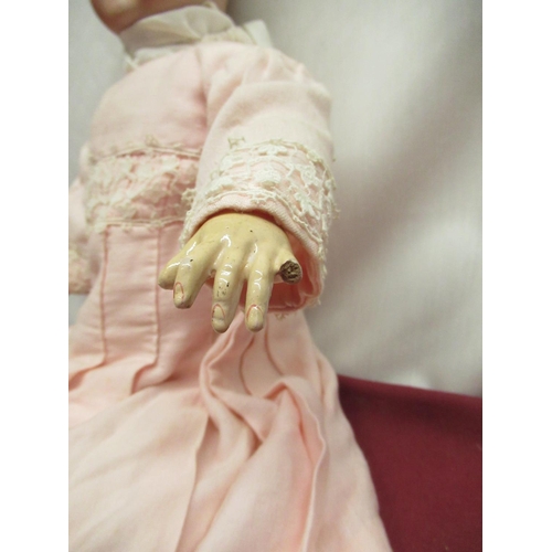 889 - Schoenau & Hoffmeister bisque headed doll marked to neck 1909 4, wearing a pink dress with lace deta... 